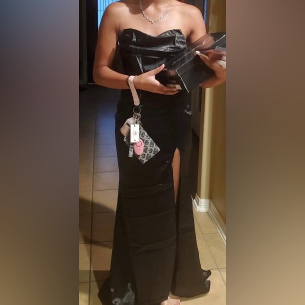 A satin black dress with a slit